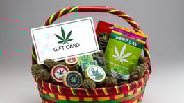 Gift Card basket with a gift card as the featured item. The basket should have hemp related products in it including buds. The gift card should say only _Gift Card_ on it. It should be colorful and should be hol